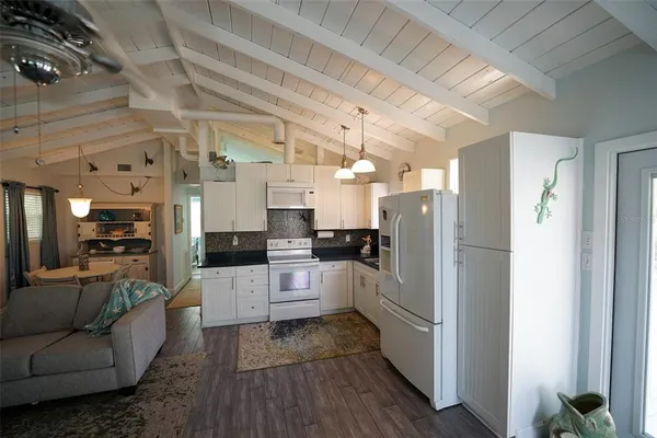 a kitchen with stainless steel appliances kitchen island granite countertop a refrigerator and a stove