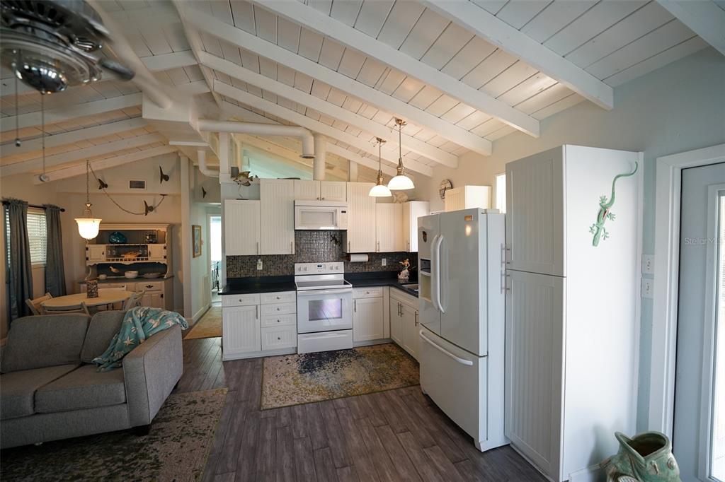 3480 Harbor Drive Weeki Wachee, FL 34607 - Photo 12 of 31 a kitchen with stainless steel appliances kitchen island granite countertop a refrigerator and a stove