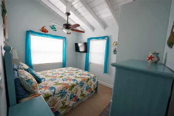 a bedroom with a bed dresser and a window