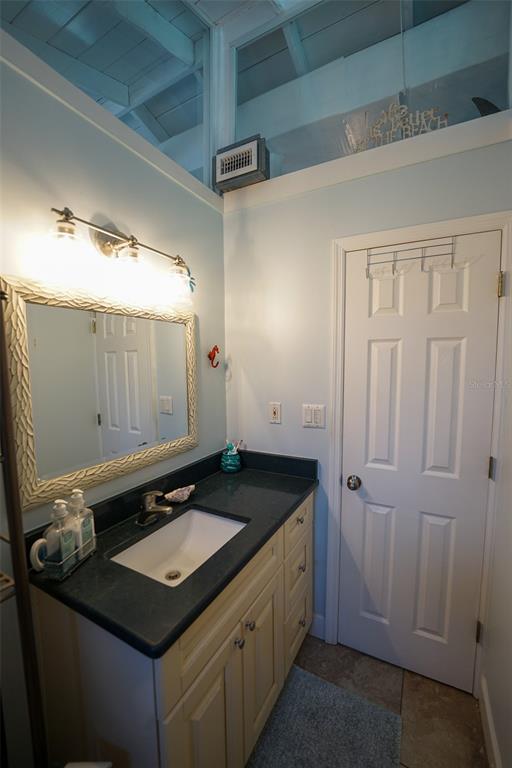 3480 Harbor Drive Weeki Wachee, FL 34607 - Photo 26 of 31 a bathroom with a granite countertop sink and a mirror