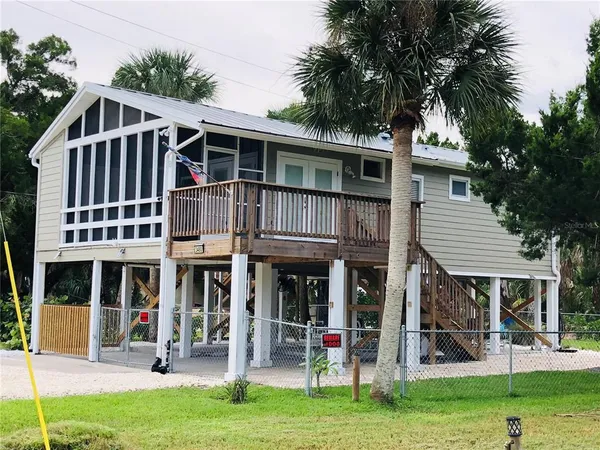 a front view of a house with a yard table and chairs