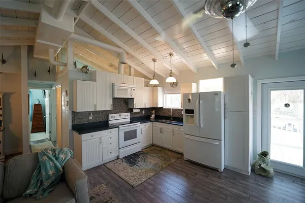a kitchen with sink cabinets and stainless steel appliances