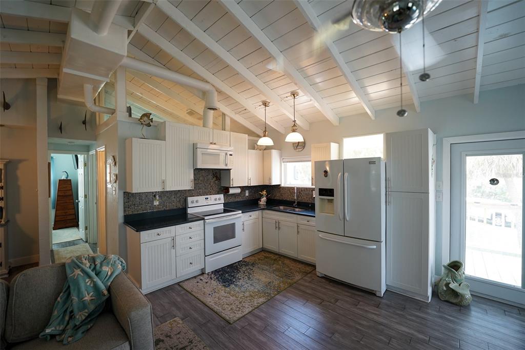 3480 Harbor Drive Weeki Wachee, FL 34607 - Photo 10 of 31 a kitchen with sink cabinets and stainless steel appliances