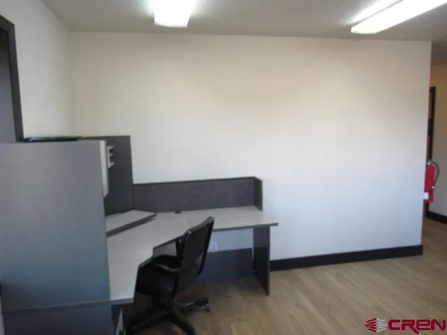 a workspace with furniture and wooden floor