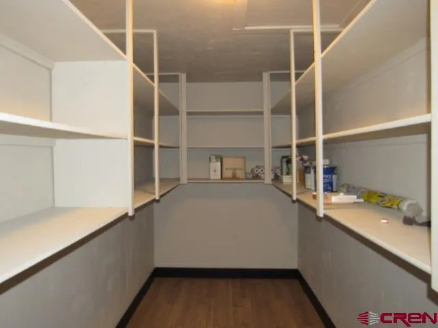 a view of walk in closet with empty racks