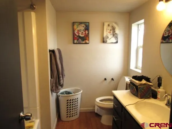 a bathroom with a sink vanity mirror and toilet