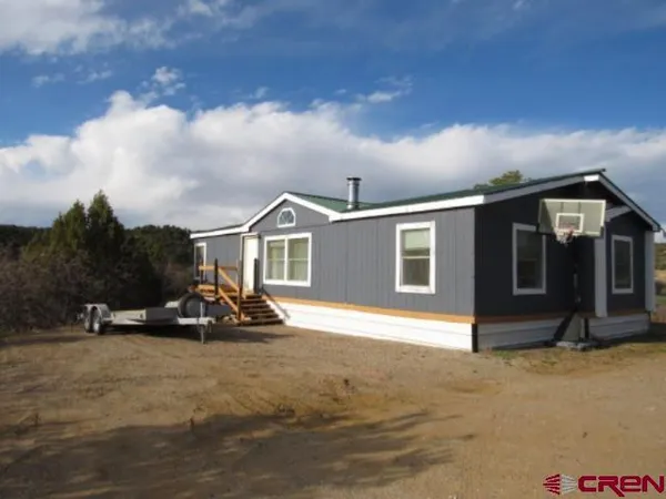a view of the house with sitting area and roof