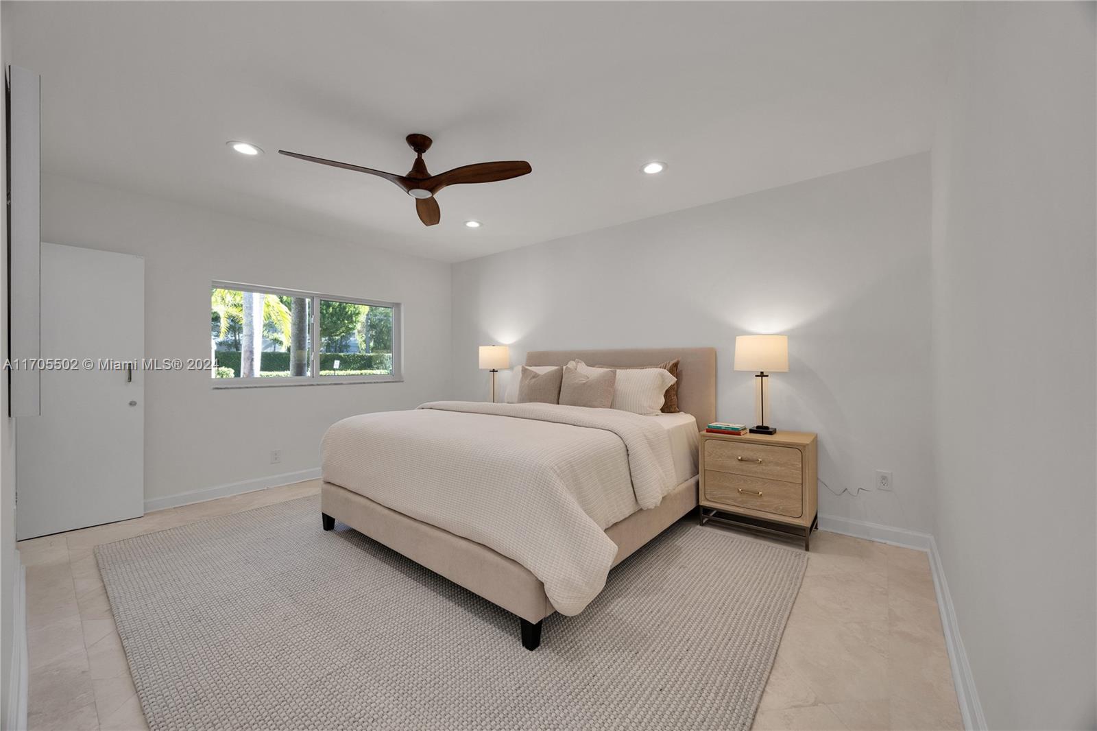 3566 Rockerman Road Miami, FL 33133 - Photo 26 of 43 a bedroom with a large bed and a chandelier