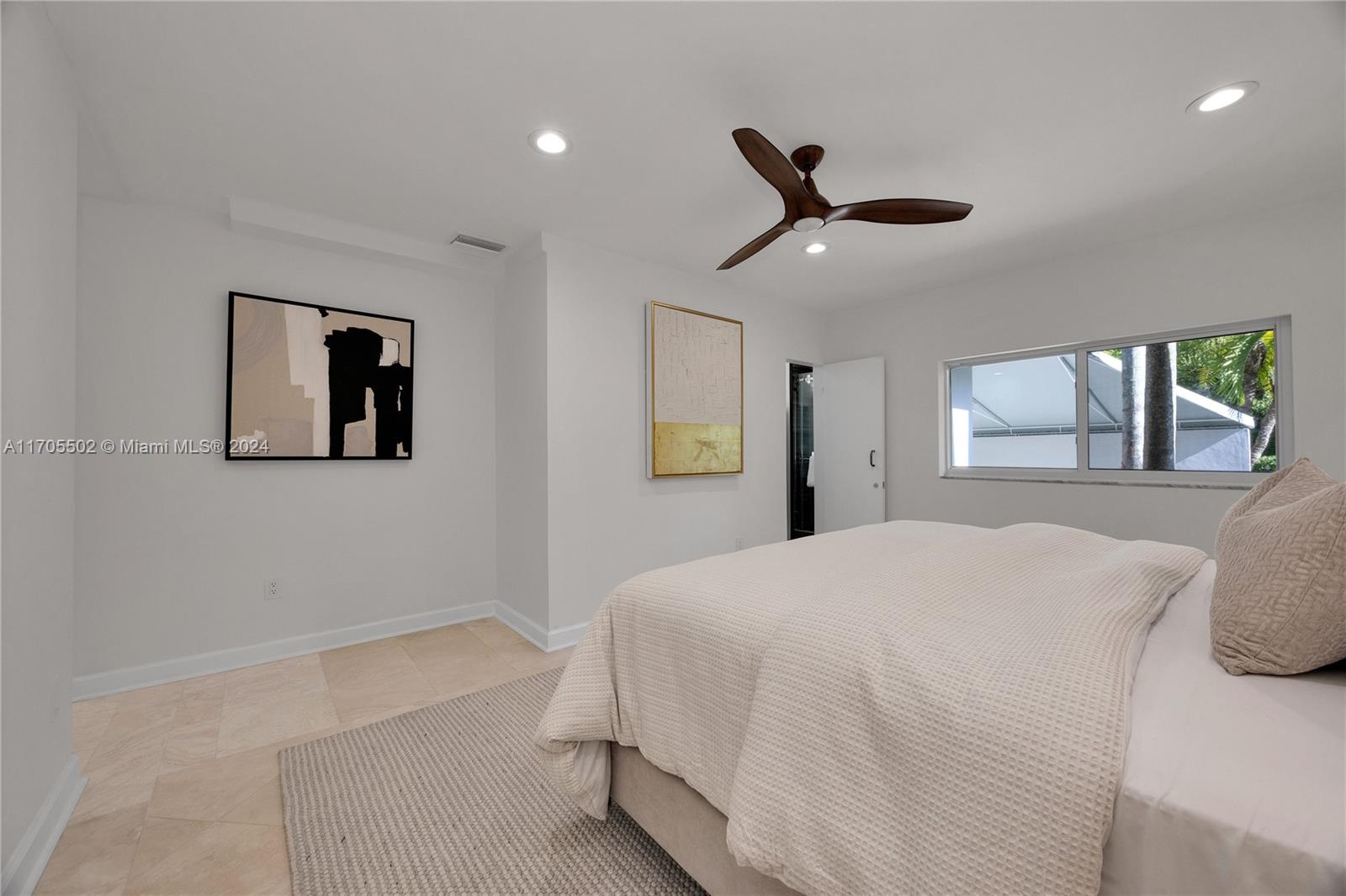 3566 Rockerman Road Miami, FL 33133 - Photo 27 of 43 a bedroom with a bed and a large mirror