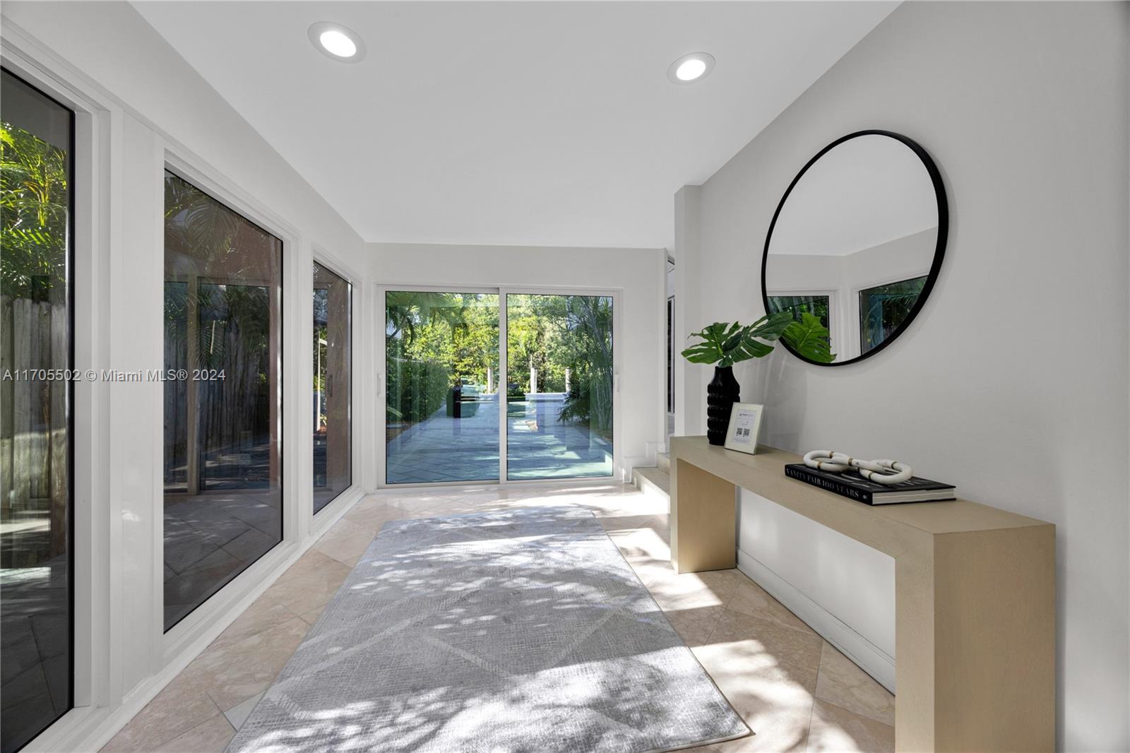 3566 Rockerman Road Miami, FL 33133 - Photo 6 of 43 a kitchen with white cabinets and a window