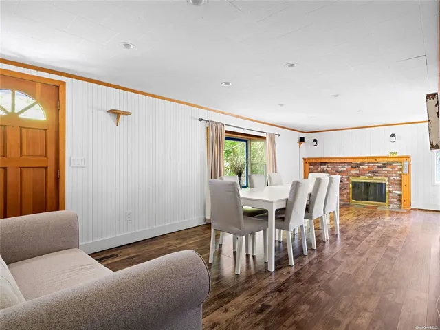 a dining room with furniture and wooden floor