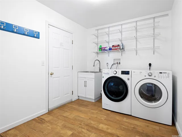 a utility room with sink dryer and washer