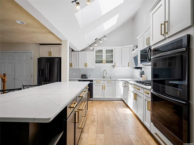 a kitchen with a stove a sink and a refrigerator