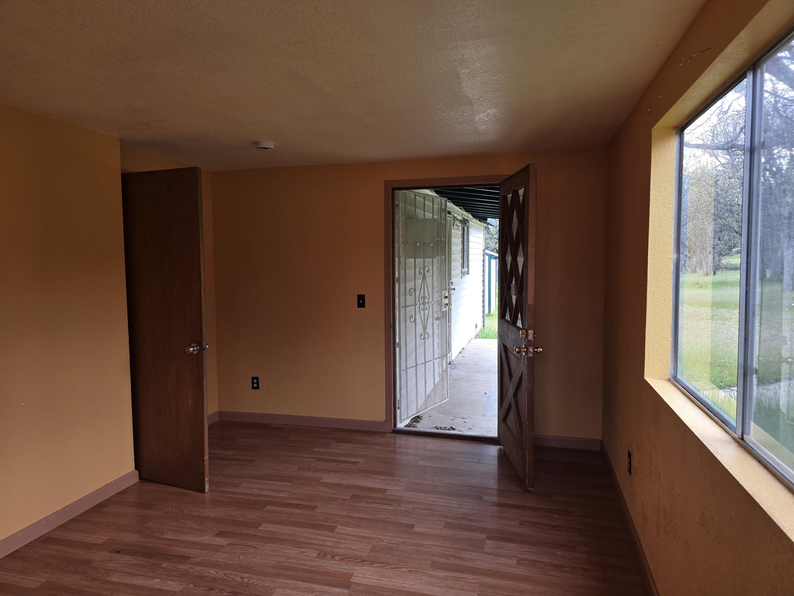 12750 Highway 3 Hayfork, CA 96041 - Photo 21 of 22 an empty room with wooden floor and windows