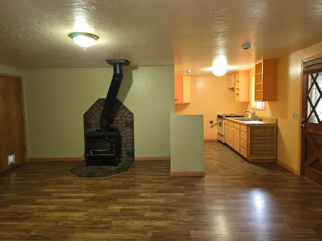 a kitchen with stainless steel appliances a refrigerator and wooden floor