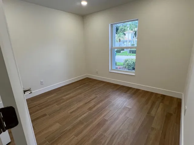 a view of room with window and hardwood floor