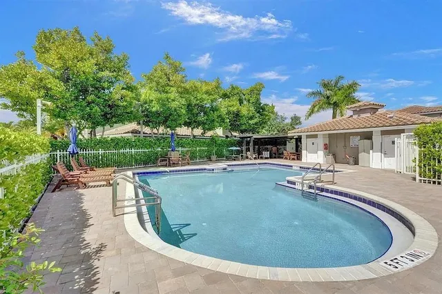 a view of a house with swimming pool and sitting area