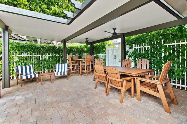 a view of a patio with a table chairs and a backyard