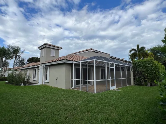 a view of an house with backyard space and garden