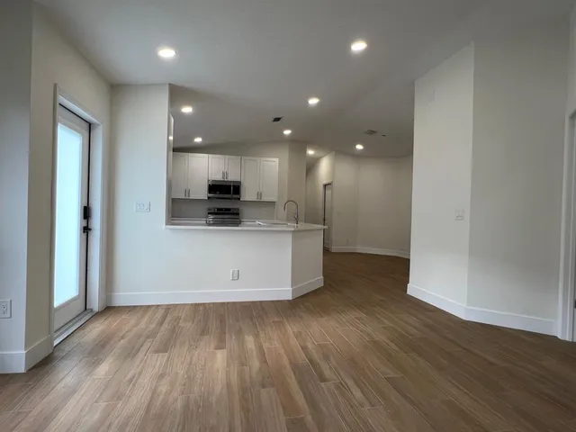 a view of kitchen with cabinets and wooden floor