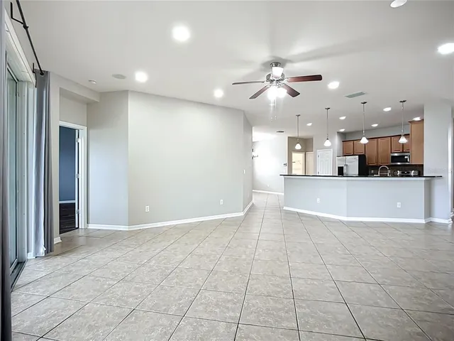 an empty room with windows and chandelier