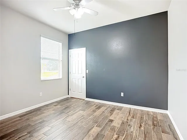 a view of a swimming pool with lawn chairs