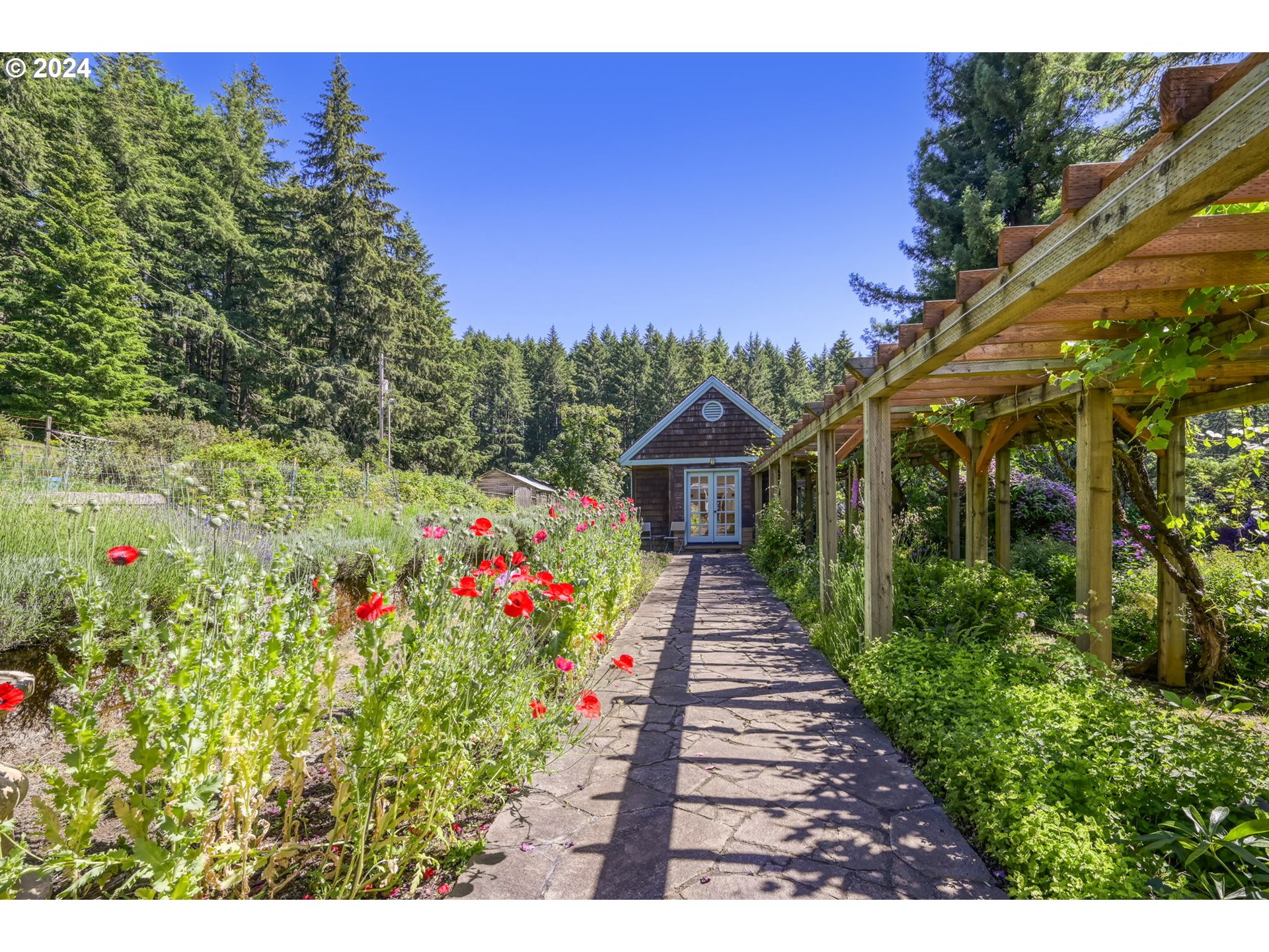 36245 Wagner Lane Cottage Grove, OR 97424 - Photo 32 of 45 a view of a pathway covered with flower plants