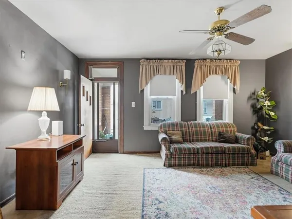 a living room with furniture and a chandelier