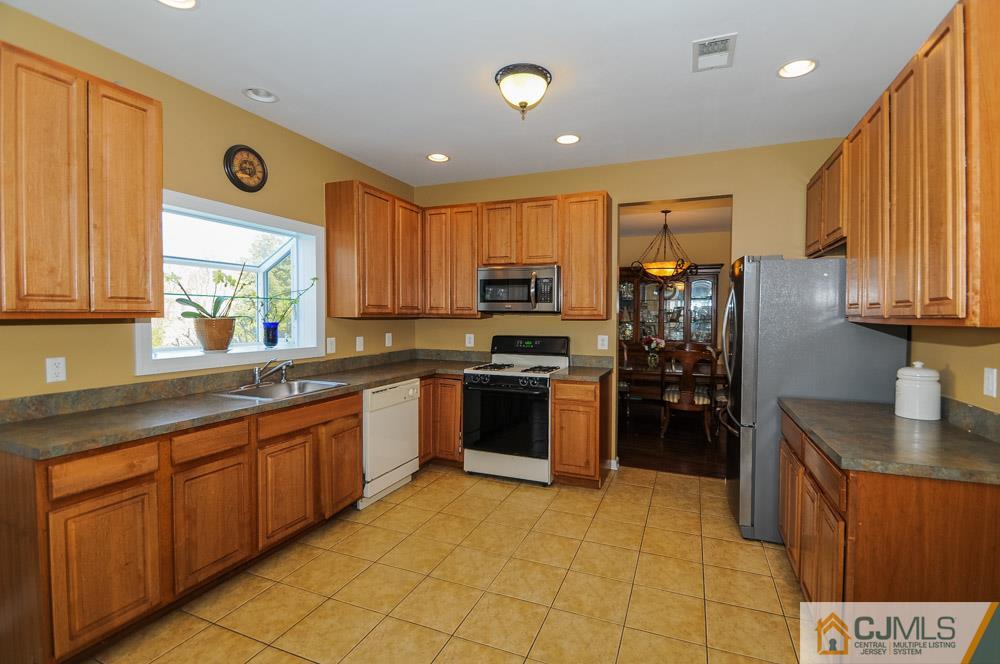 19 Cannon Road Old Bridge, NJ 08857 - Photo 14 of 22 a large kitchen with stainless steel appliances granite countertop a stove refrigerator and a sink