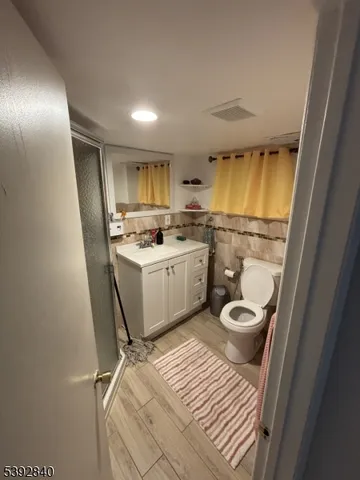a bathroom with a sink a toilet a mirror and vanity