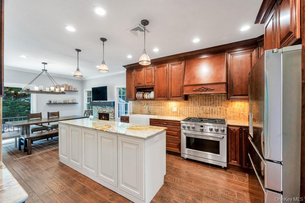 357 Wynsum Avenue Merrick, NY 11566 - Photo 20 of 40 a kitchen with stainless steel appliances granite countertop a sink stove and refrigerator