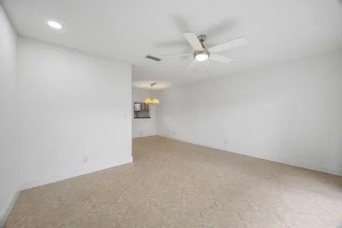 an empty room with a ceiling fan and a ceiling fan