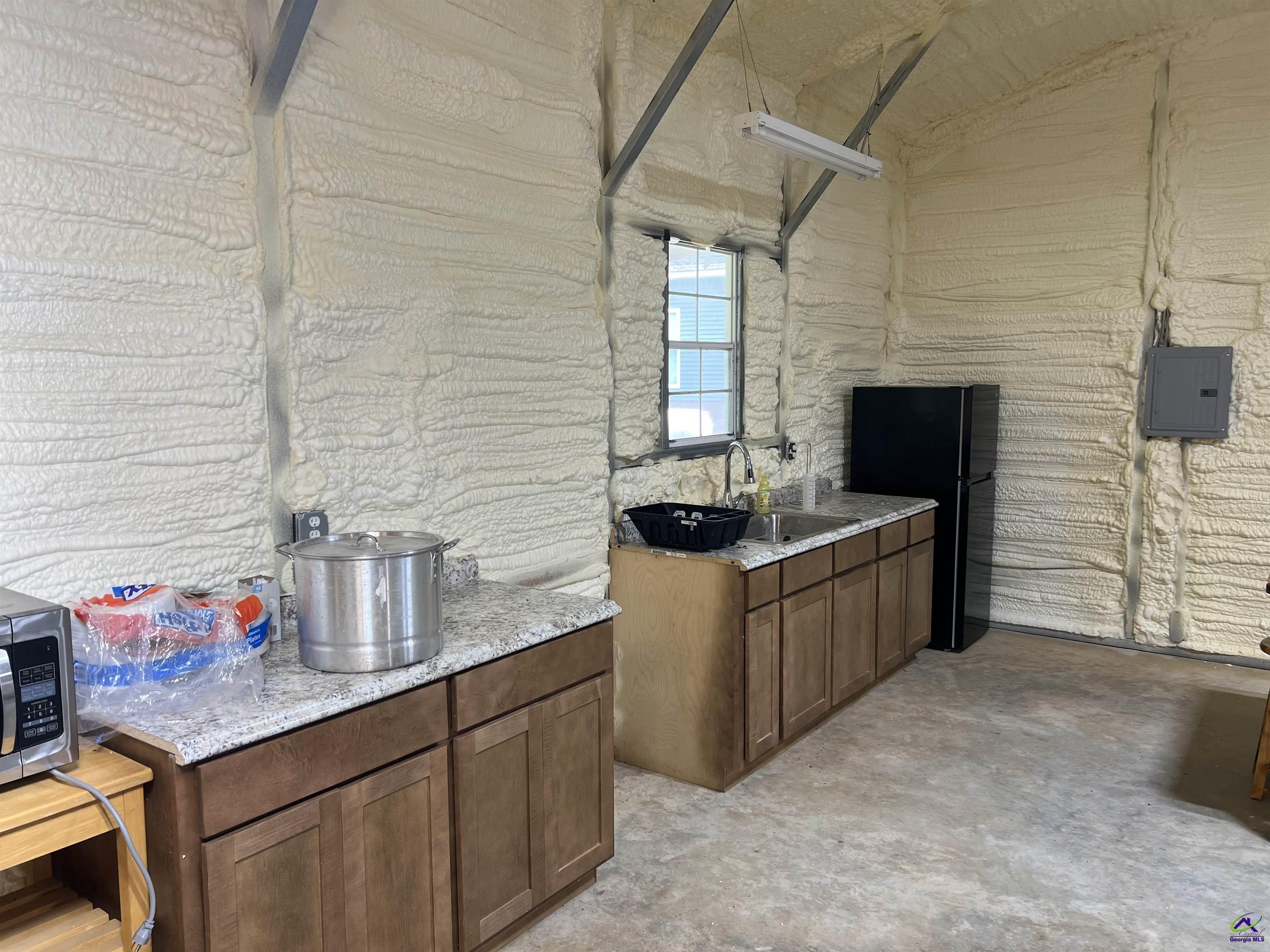 2203 Old Macon Road Montrose, GA 31065 - Photo 61 of 64 a kitchen with stainless steel appliances granite countertop a sink stove and cabinets