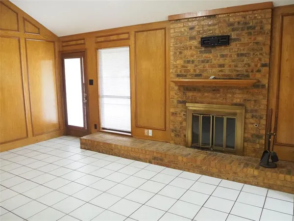 a view of a livingroom with an empty space and a fireplace