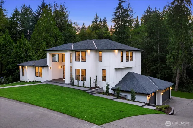 a front view of a house with a yard and green space