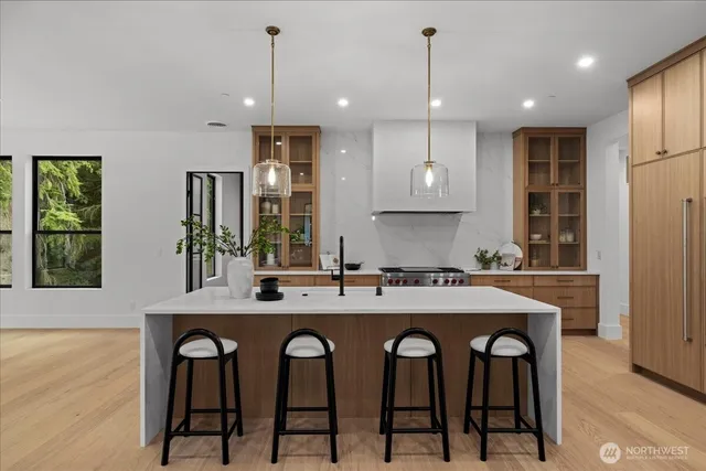 a kitchen with cabinets and chairs