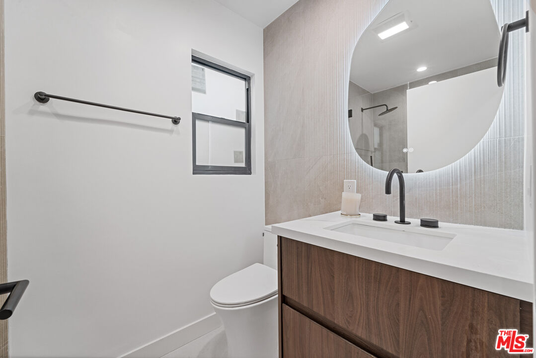3305 Ocean Front Walk, Unit 1 & 2 Marina del Rey, CA 90292 - Photo 12 of 44 a bathroom with a sink a toilet and a mirror