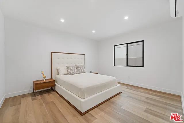 a bedroom with a bed and a night stand