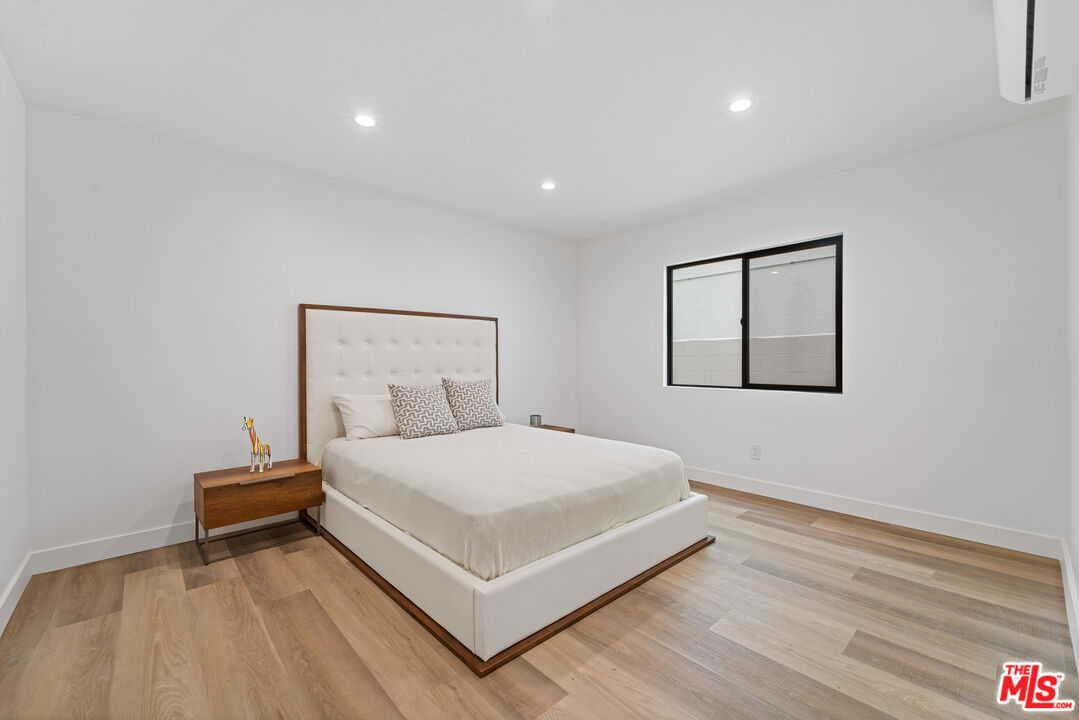 3305 Ocean Front Walk, Unit 1 & 2 Marina del Rey, CA 90292 - Photo 13 of 44 a bedroom with a bed and a night stand