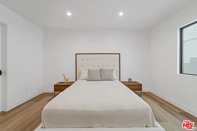 a bedroom with a bed and a night stand