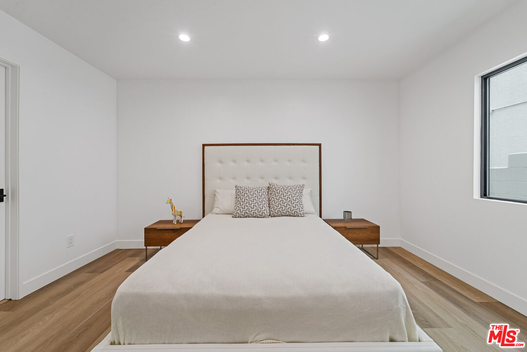 3305 Ocean Front Walk, Unit 1 & 2 Marina del Rey, CA 90292 - Photo 14 of 44 a bedroom with a bed and a night stand