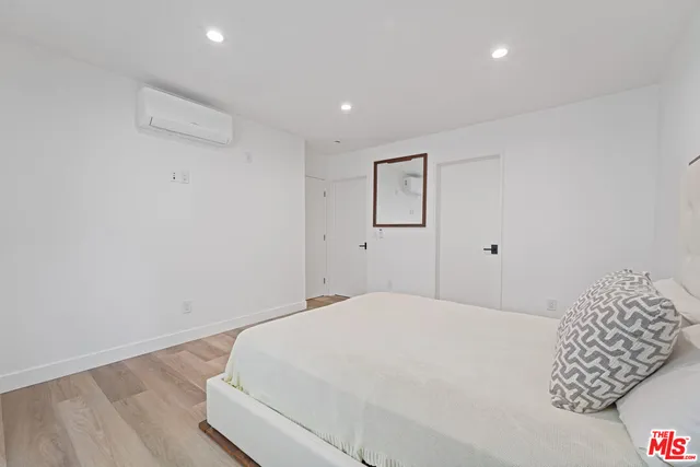 a large white bed in a white room