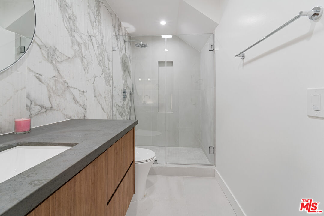 3305 Ocean Front Walk, Unit 1 & 2 Marina del Rey, CA 90292 - Photo 17 of 44 a bathroom with a granite countertop sink a toilet and shower