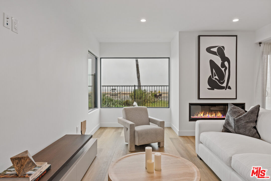 3305 Ocean Front Walk, Unit 1 & 2 Marina del Rey, CA 90292 - Photo 3 of 44 a living room with furniture and a large window