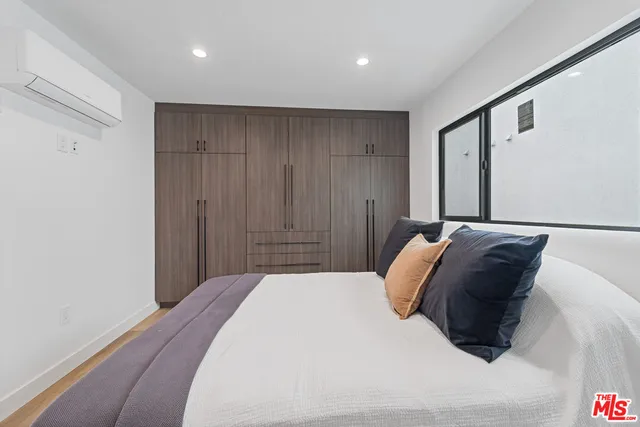 a bedroom with a bed and a vanity