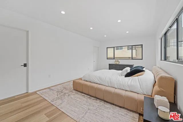 a bedroom with a bed and a couch