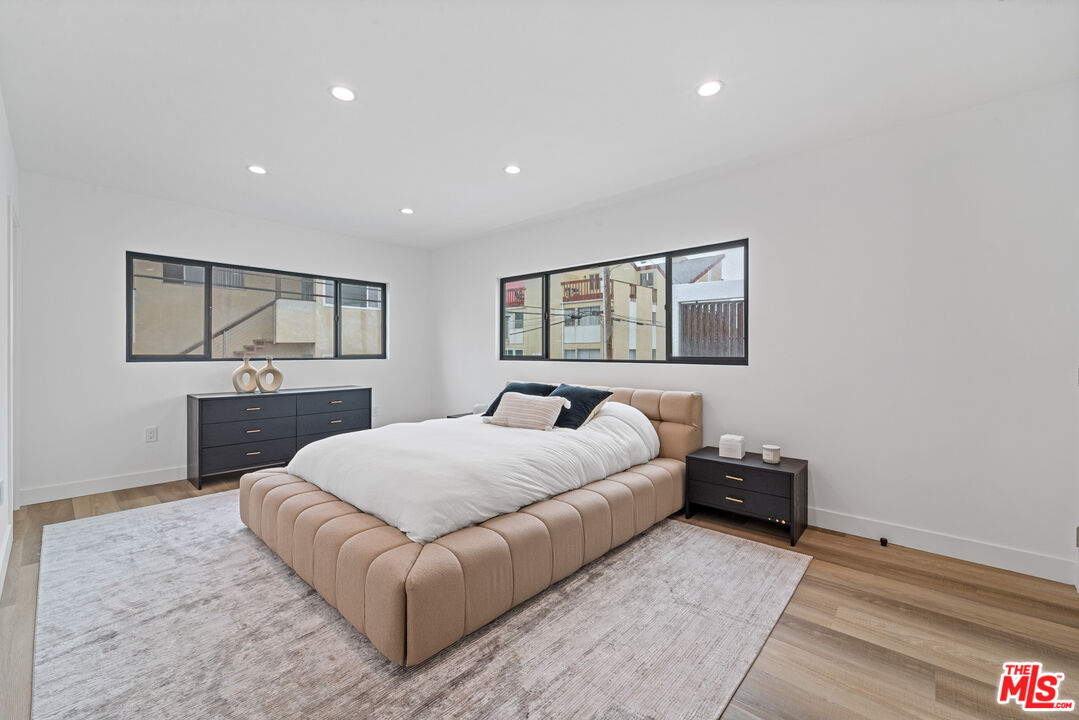 3305 Ocean Front Walk, Unit 1 & 2 Marina del Rey, CA 90292 - Photo 37 of 44 a bedroom with a bed and a flat screen tv