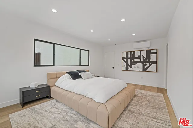 a bedroom with a large bed and a couch