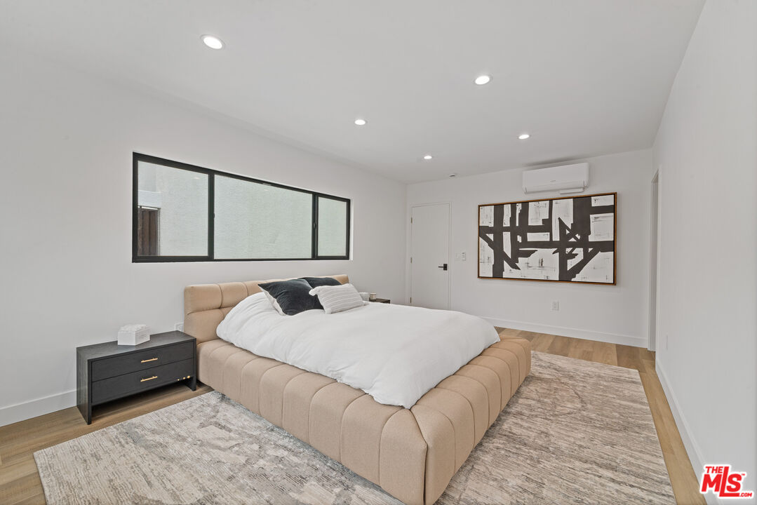 3305 Ocean Front Walk, Unit 1 & 2 Marina del Rey, CA 90292 - Photo 38 of 44 a bedroom with a large bed and a couch