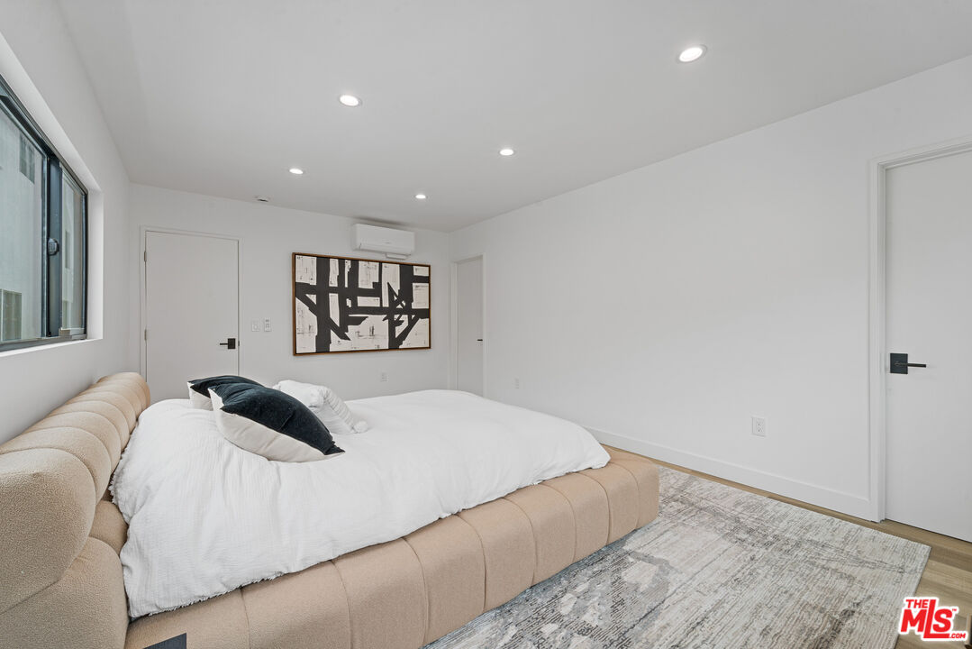 3305 Ocean Front Walk, Unit 1 & 2 Marina del Rey, CA 90292 - Photo 40 of 44 a bedroom with a large bed and a chandelier